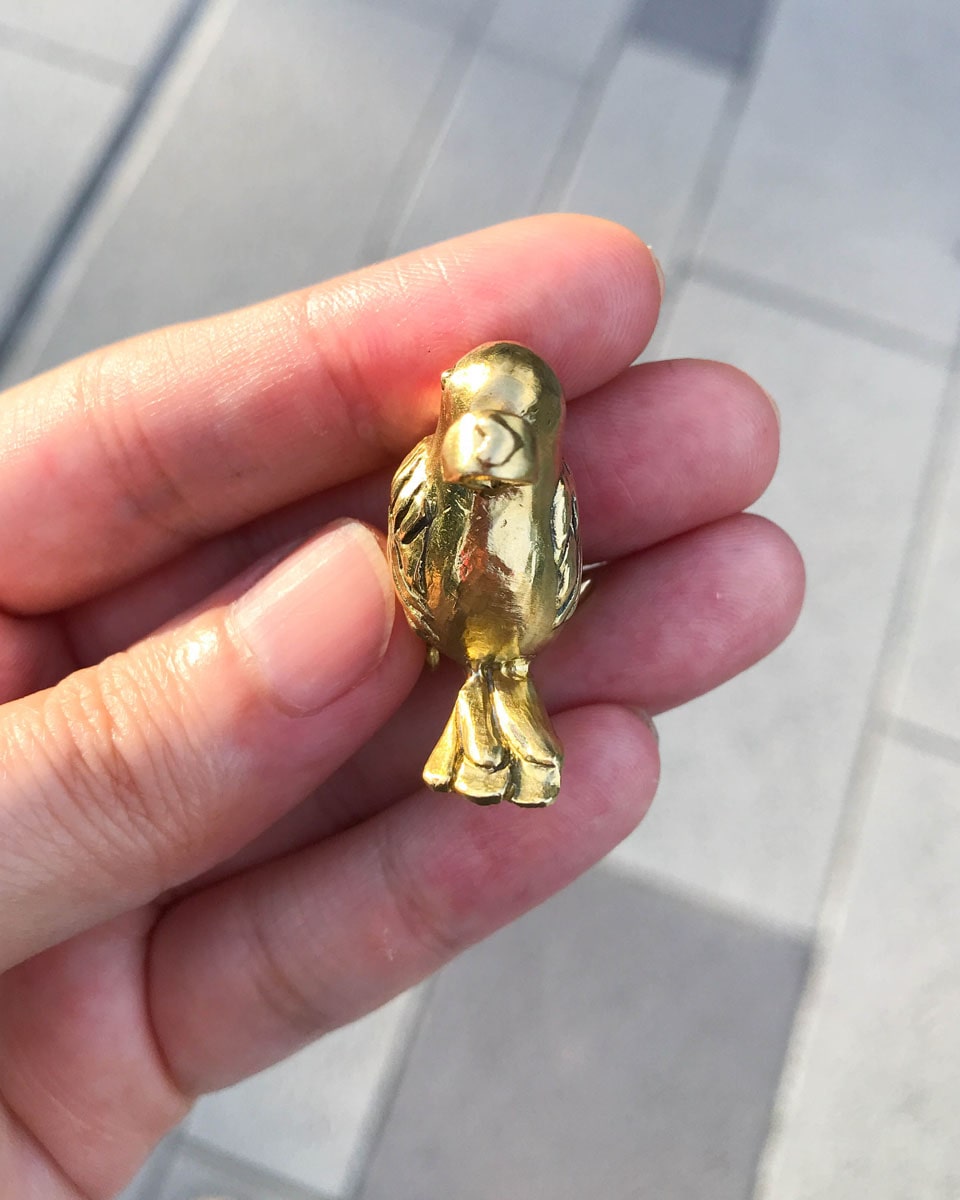 handmade brass pooping bird pendant that poops out a freshwater pearl, by fake plastic love
