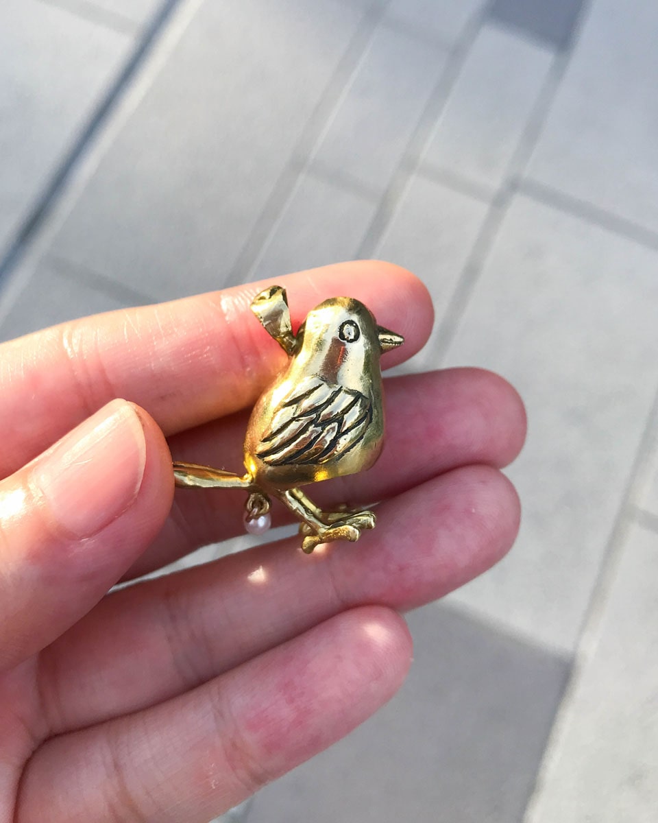 handmade brass pooping bird pendant that poops out a freshwater pearl, by fake plastic love