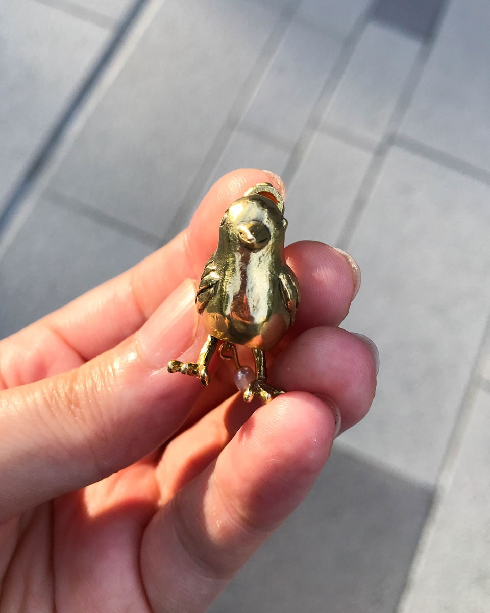 handmade brass pooping bird pendant that poops out a freshwater pearl, by fake plastic love