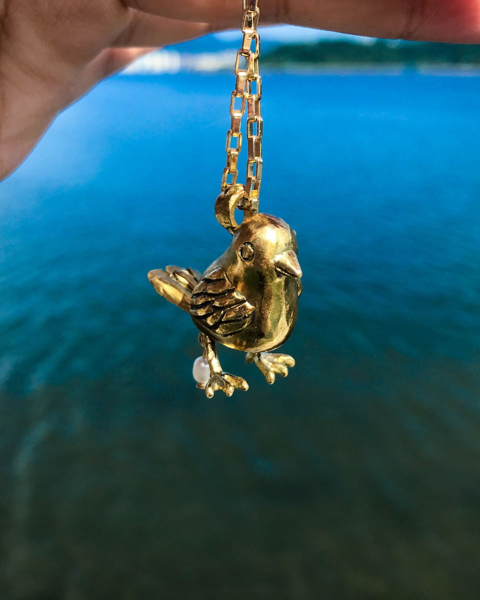 handmade brass pooping bird pendant that poops out a freshwater pearl, by fake plastic love