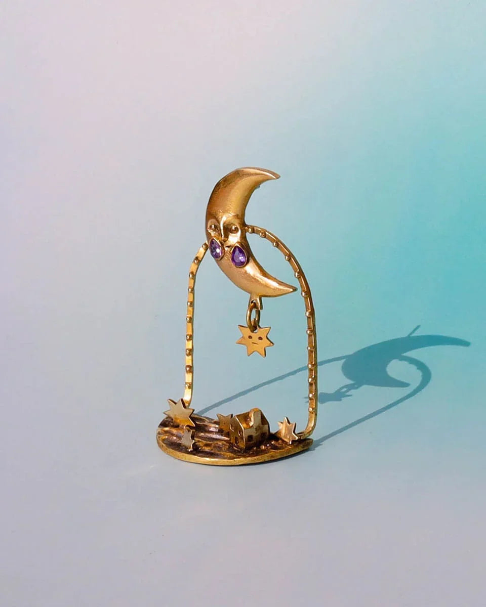 "Where The Fallen Stars Return As Tides" brass statement earrings: a moon with purple CZ tears drops stars into an ocean scene with a tiny house. Wearable poetry by fake plastic love