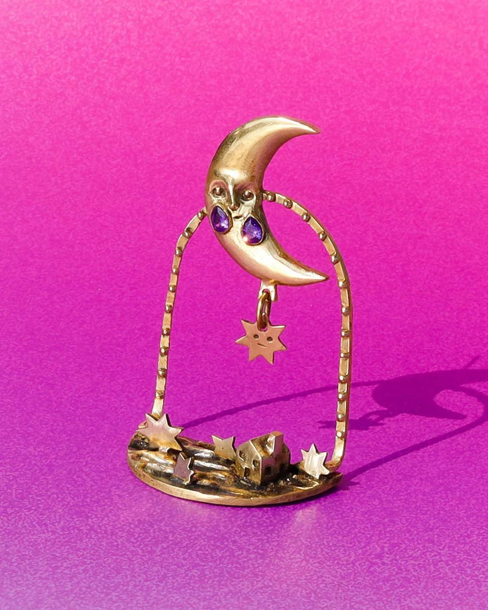 "Where The Fallen Stars Return As Tides" brass statement earrings: a moon with purple CZ tears drops stars into an ocean scene with a tiny house. Wearable poetry by fake plastic love