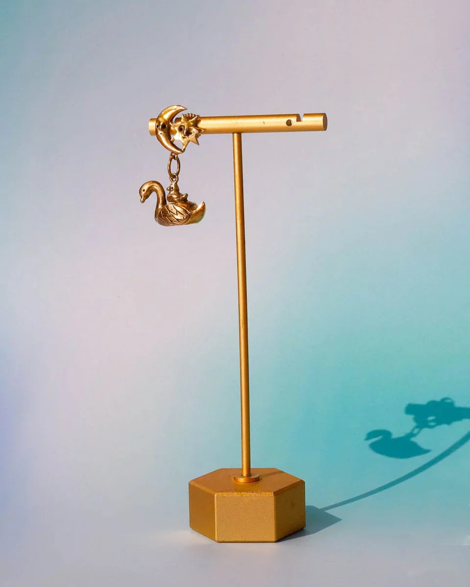 The Swan, cygnet and the moon earring featuring a baby swan riding on its parent, topped with a smiling moon and star. Handmade with lost-wax casting in brass—a tiny ode to love and cosmic connections