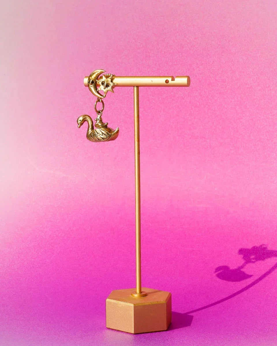 The Swan, cygnet and the moon earring featuring a baby swan riding on its parent, topped with a smiling moon and star. Handmade with lost-wax casting in brass—a tiny ode to love and cosmic connections