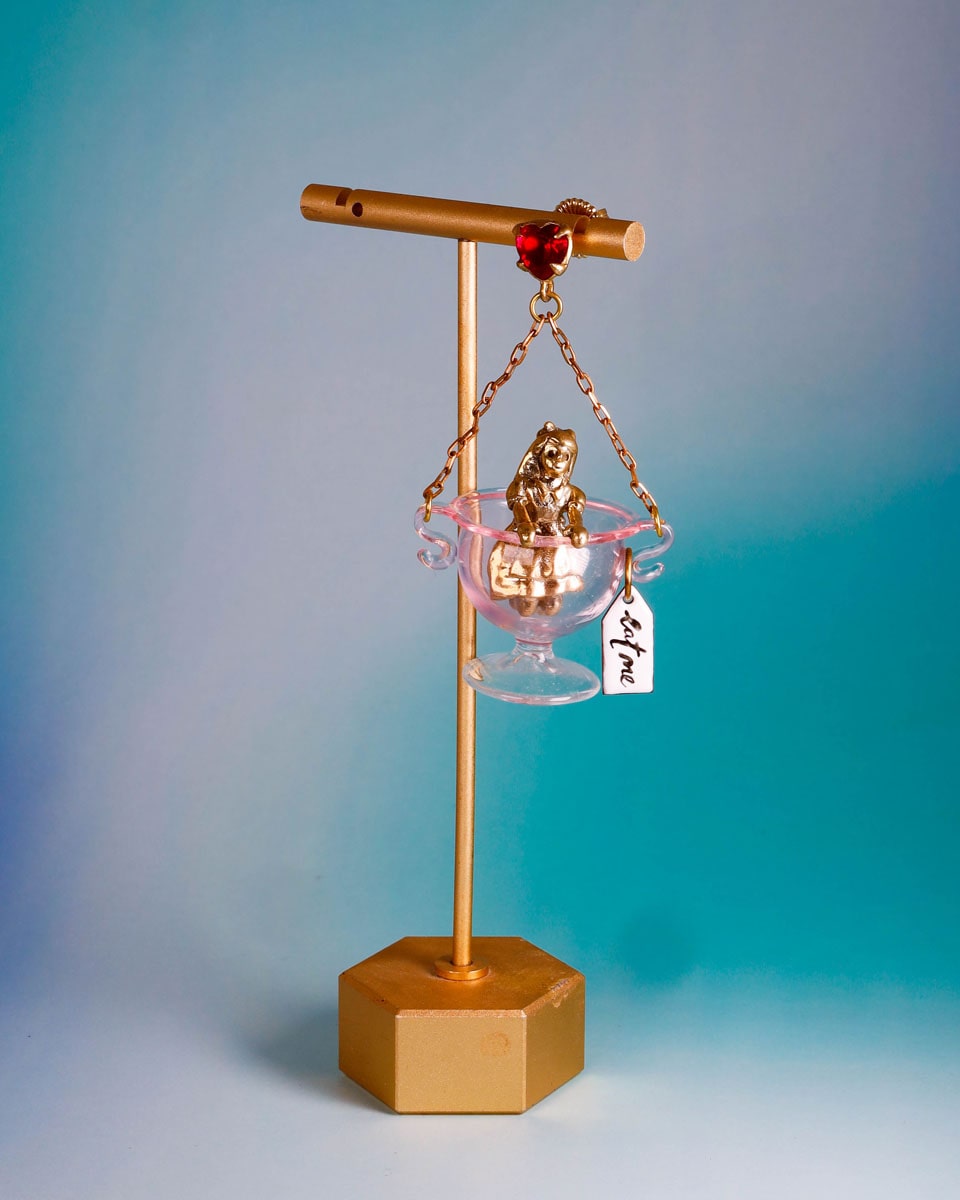 Handmade Alice in Wonderland earring/pendant with glass bowl, brass figure, and "Eat Me" vitreous enamel tag, handmade by fake plastic love
