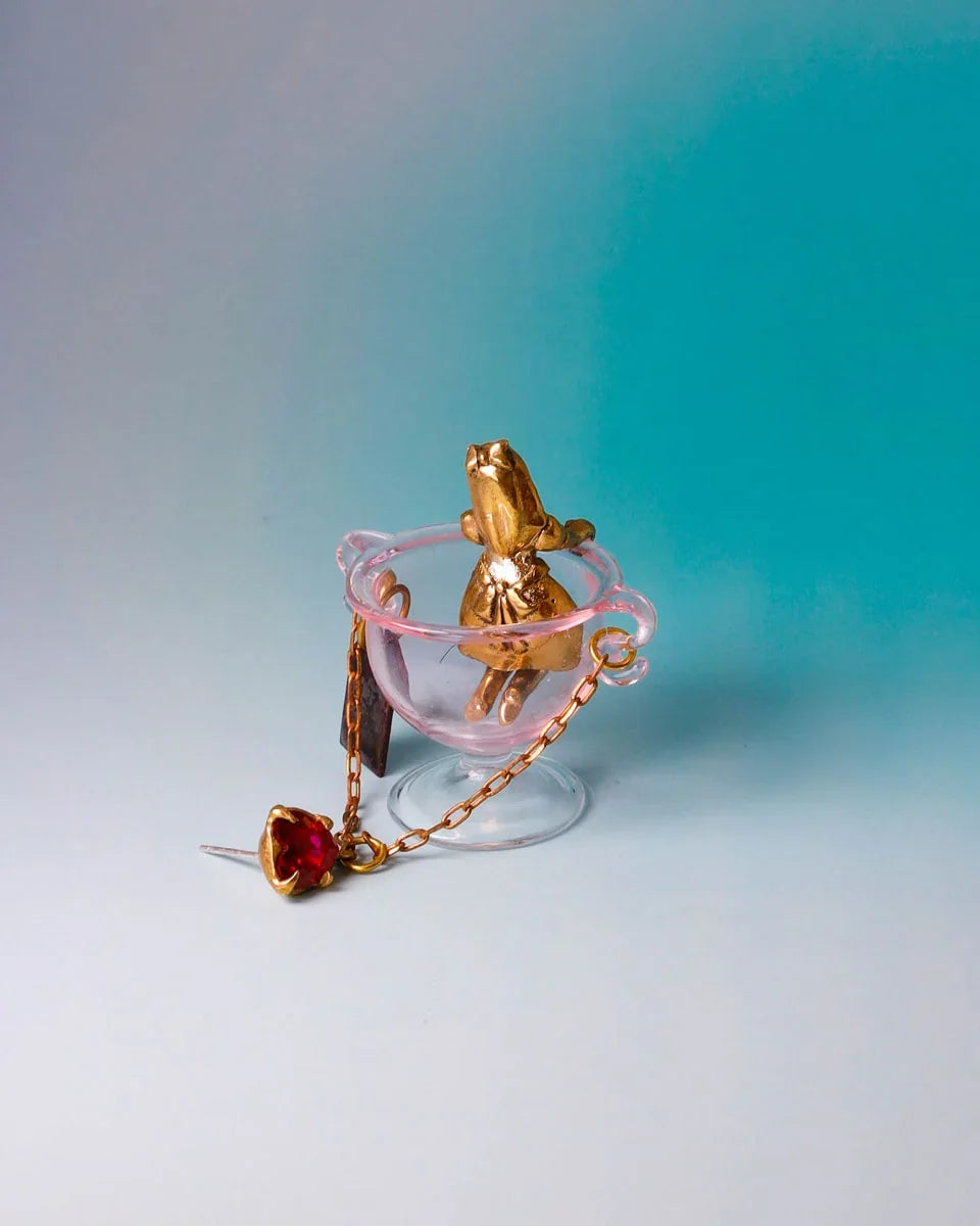 Handmade Alice in Wonderland earring/pendant with glass bowl, brass figure, and "Eat Me" vitreous enamel tag, handmade by fake plastic love