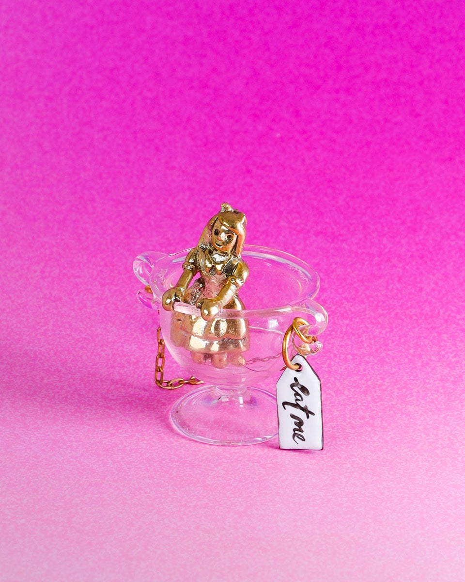 Handmade Alice in Wonderland earring/pendant with glass bowl, brass figure, and "Eat Me" vitreous enamel tag, handmade by fake plastic love