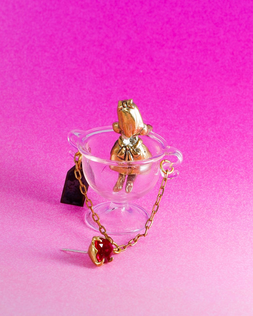Handmade Alice in Wonderland earring/pendant with glass bowl, brass figure, and "Eat Me" vitreous enamel tag, handmade by fake plastic love