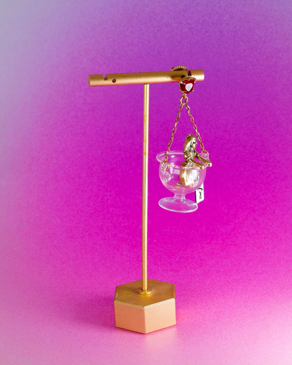 Handmade Alice in Wonderland earring/pendant with glass bowl, brass figure, and "Eat Me" vitreous enamel tag, handmade by fake plastic love