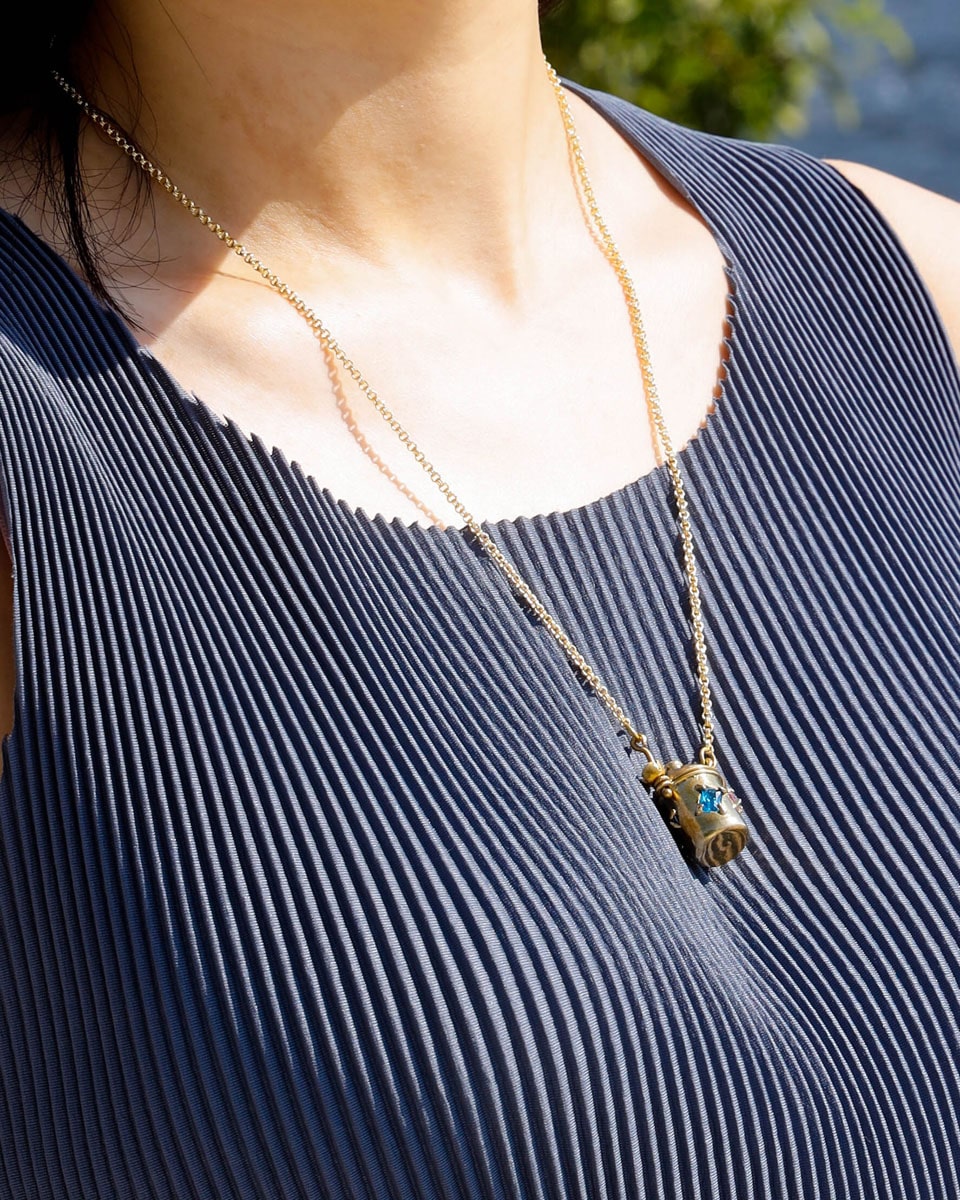 The Alchemist Locket Necklace, a handmade brass tiny container locket with cz stones and flowers details with gold plated chain, crafted by fake plastic love