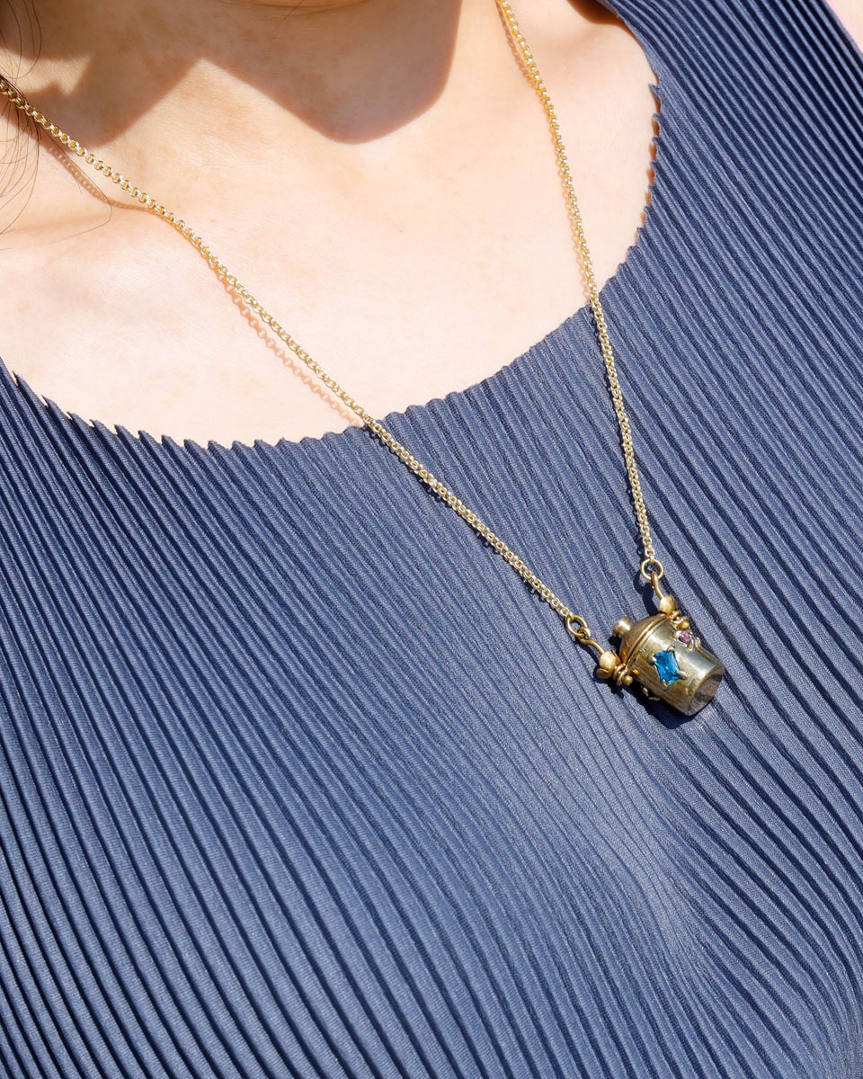 The Alchemist Locket Necklace, a handmade brass tiny container locket with cz stones and flowers details with gold plated chain, crafted by fake plastic love