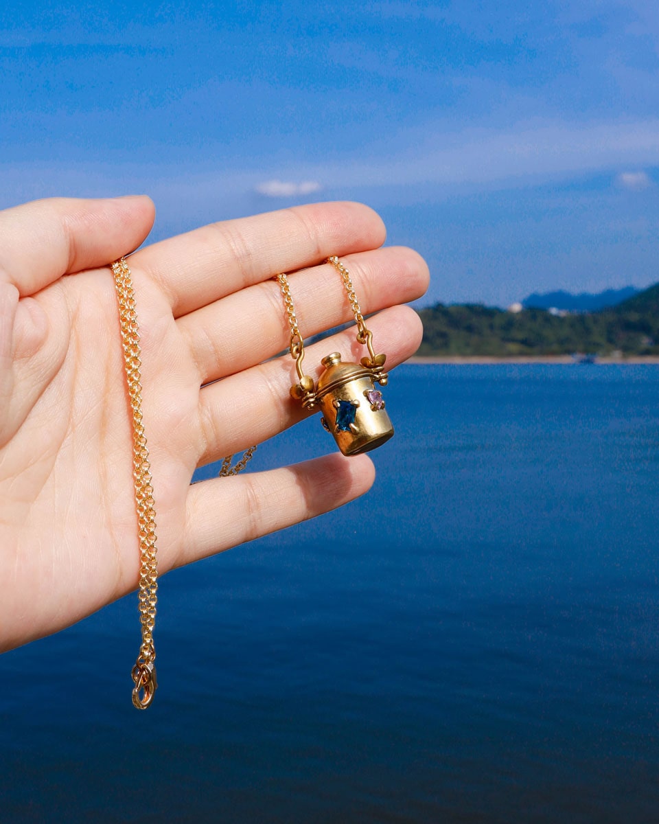 The Alchemist Locket Necklace, a handmade brass tiny container locket with cz stones and flowers details with gold plated chain, crafted by fake plastic love