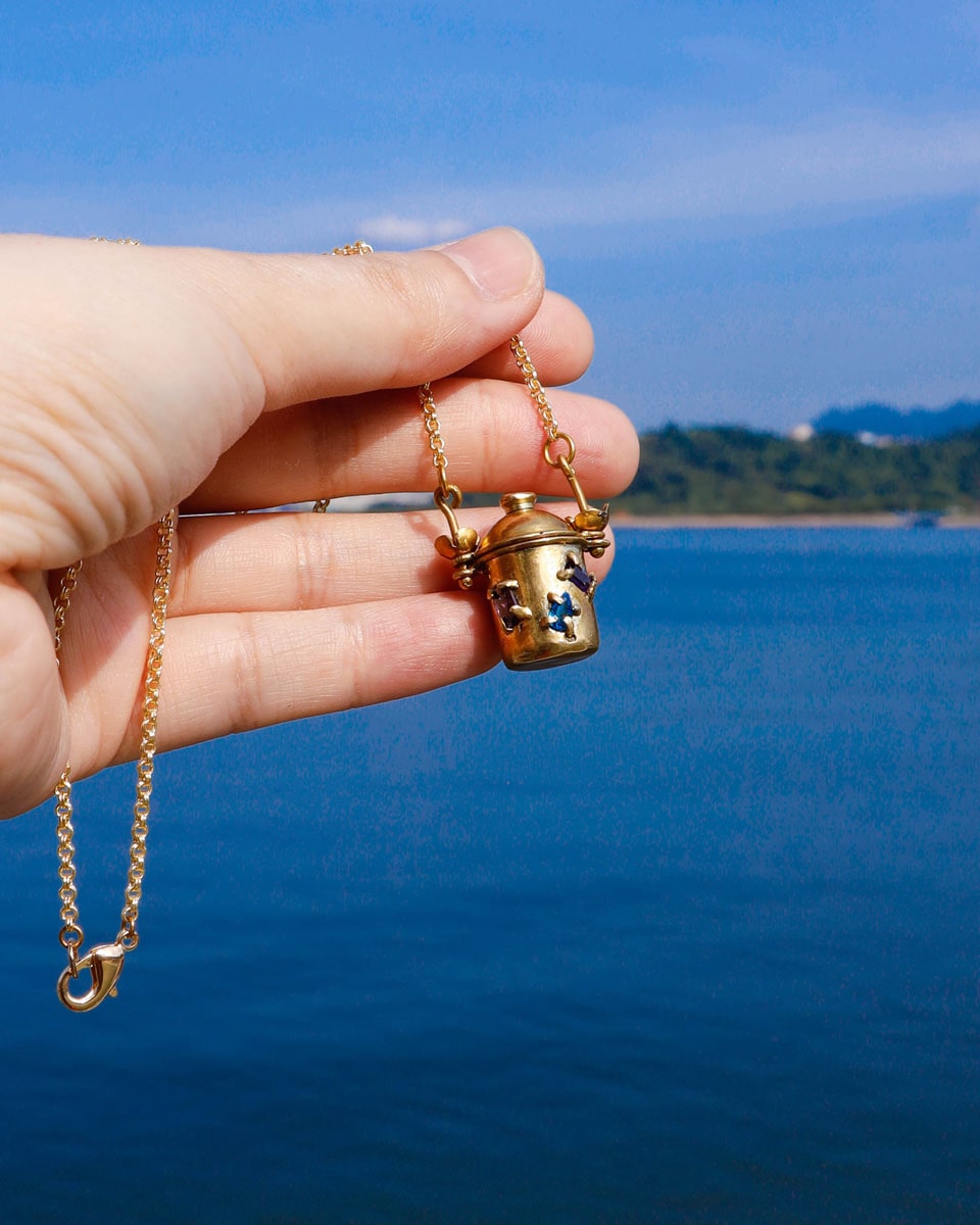 The Alchemist Locket Necklace, a handmade brass tiny container locket with cz stones and flowers details with gold plated chain, crafted by fake plastic love