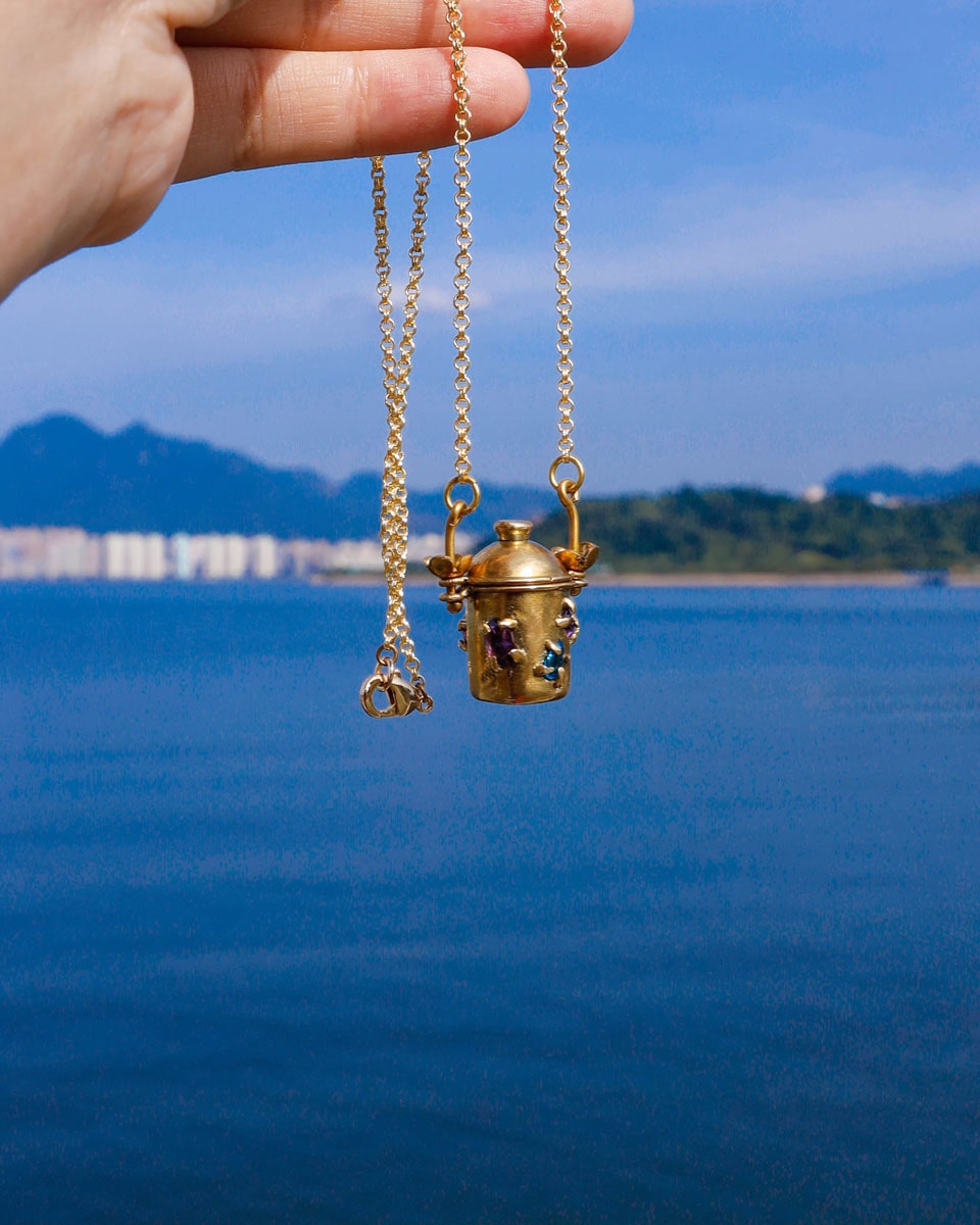 The Alchemist Locket Necklace, a handmade brass tiny container locket with cz stones and flowers details with gold plated chain, crafted by fake plastic love