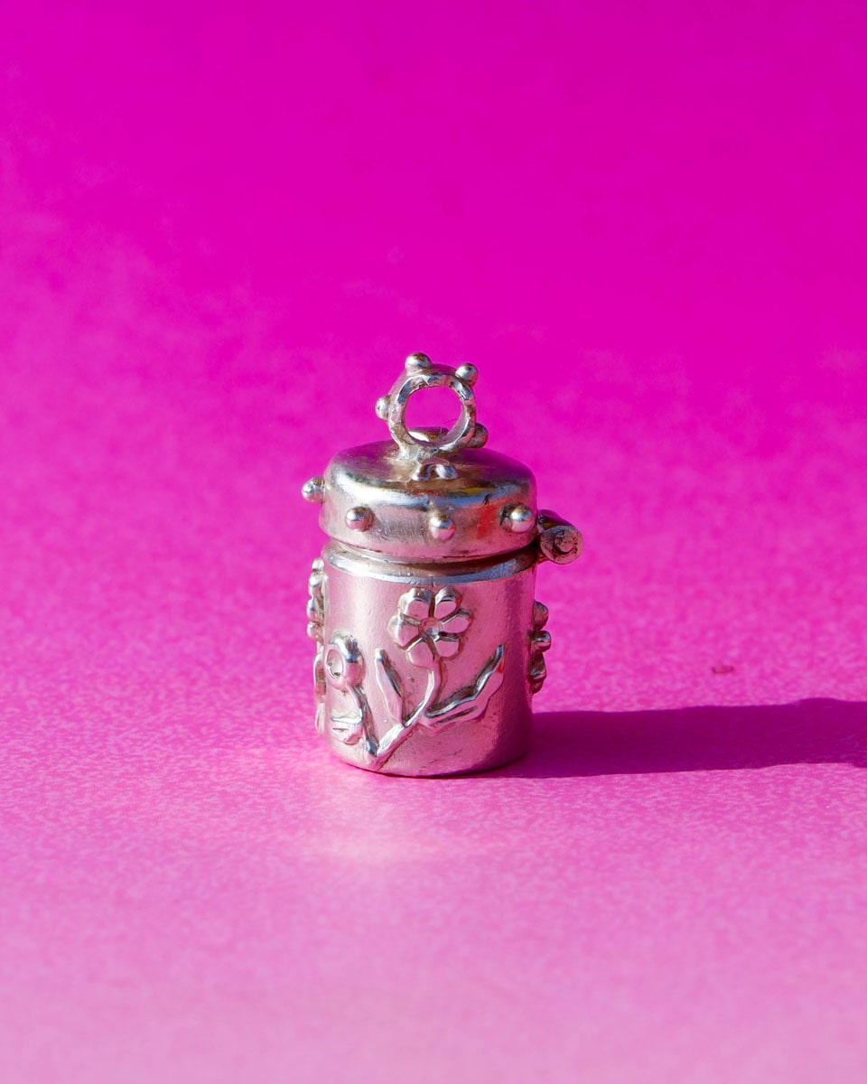 A solid sterling silver container locket pendant with flower, hand-carved with wax cast into silver, with a functional hinged lid. Handmade by fake plastic love