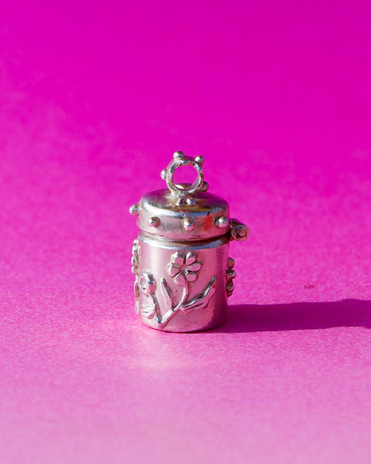 A solid sterling silver container locket pendant with flower, hand-carved with wax cast into silver, with a functional hinged lid. Handmade by fake plastic love
