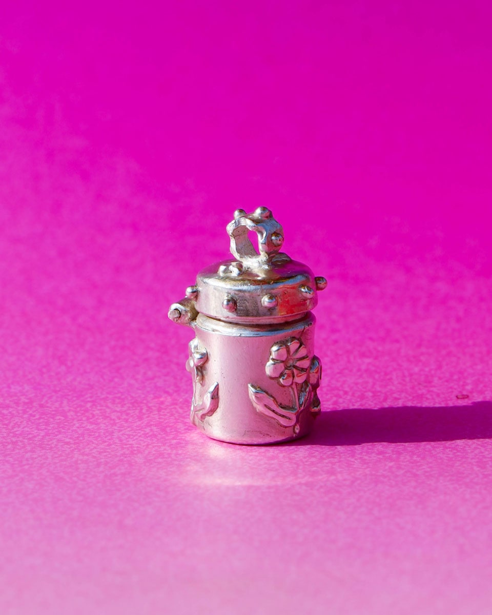 A solid sterling silver container locket pendant with flower, hand-carved with wax cast into silver, with a functional hinged lid. Handmade by fake plastic love
