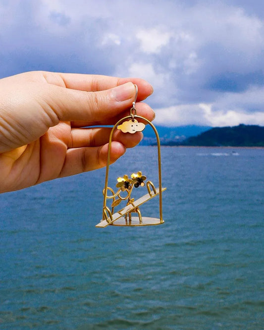 Sunny Day Playground Earrings, handmade miniature seesaw with a kinetic element, made with metal folding technique, by fake plastic love