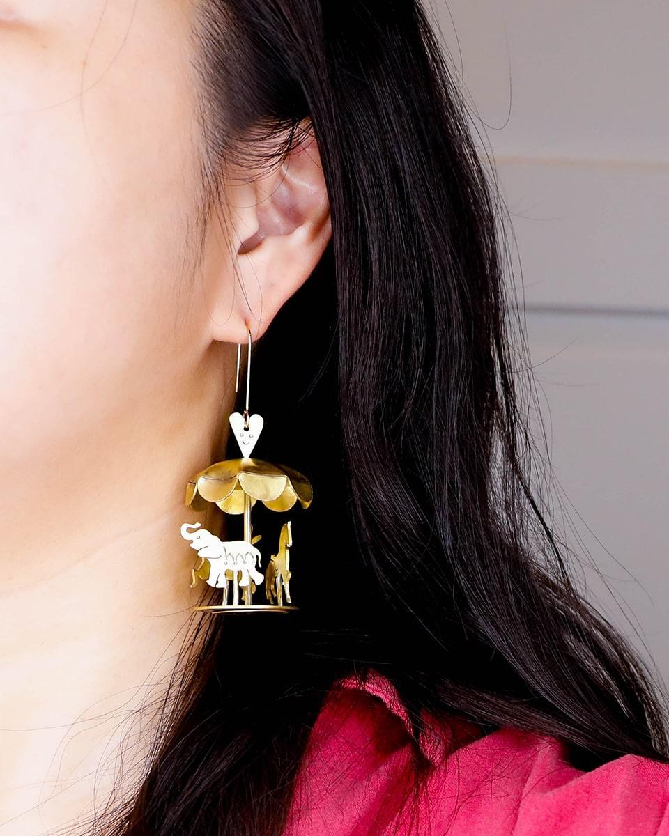 A kinetic miniature carousel earring, handmade from brass sheets, handcrafted jewellery, by fake plastic love