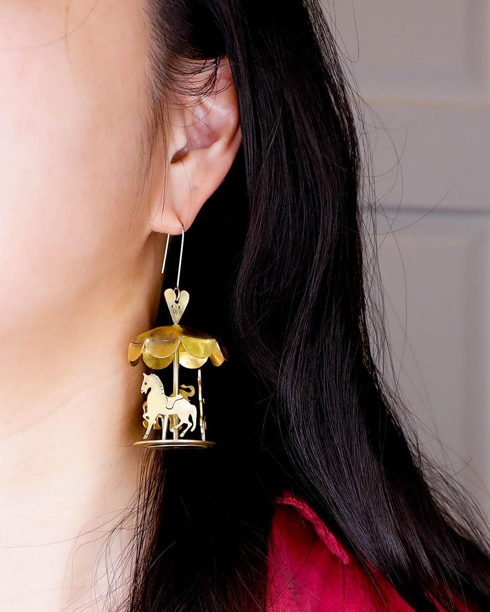 A kinetic miniature carousel earring, handmade from brass sheets, handcrafted jewellery, by fake plastic love