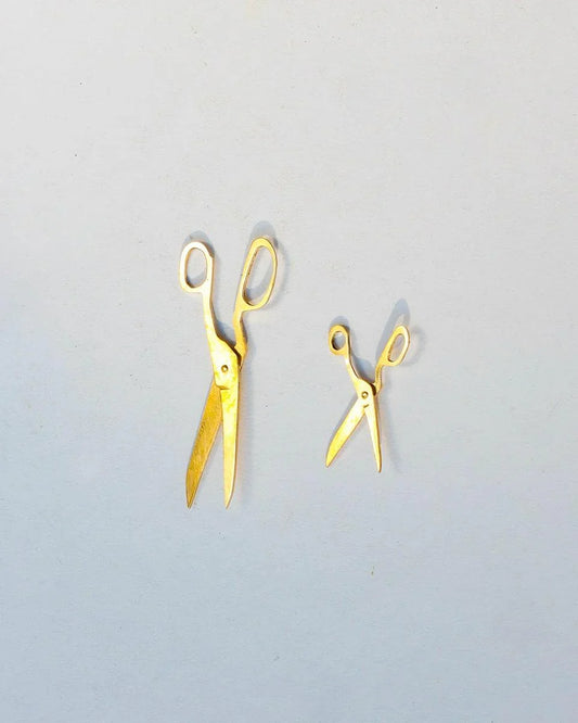 Handmade brass earrings shaped like miniature fabric scissors with kinetic blades
