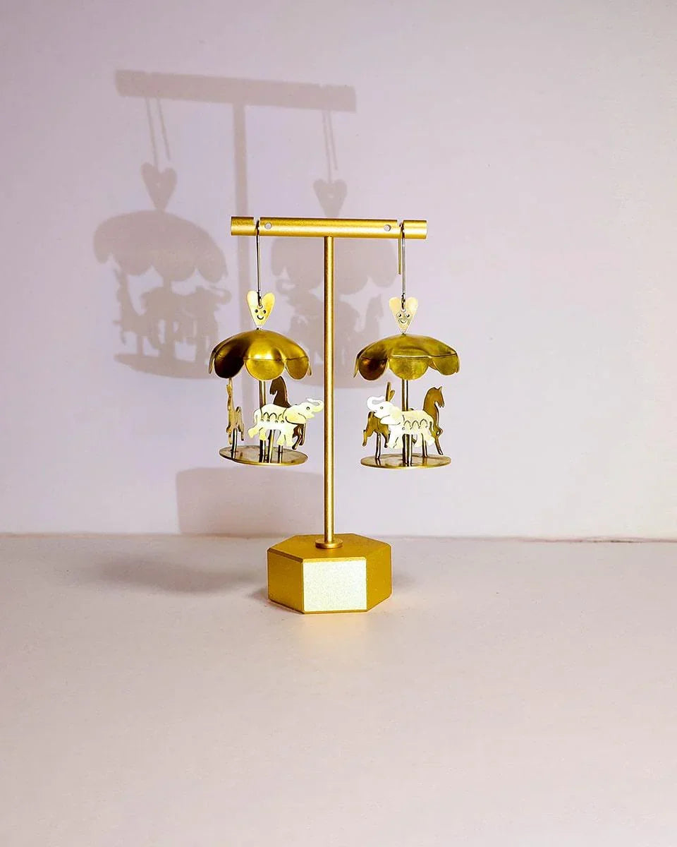 A kinetic miniature carousel earring, handmade from brass sheets, handcrafted jewellery, by fake plastic love