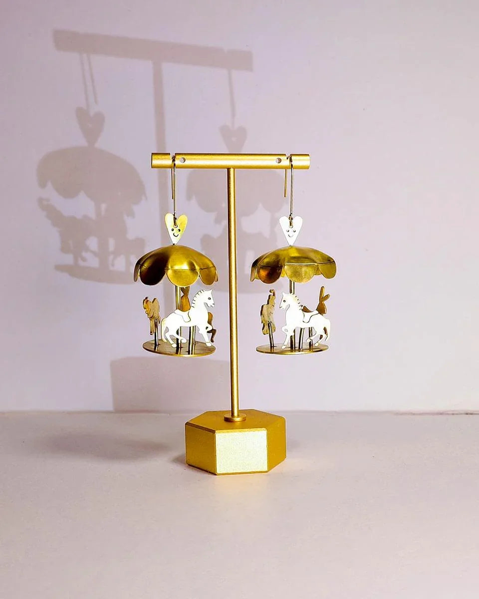A kinetic miniature carousel earring, handmade from brass sheets, handcrafted jewellery, by fake plastic love