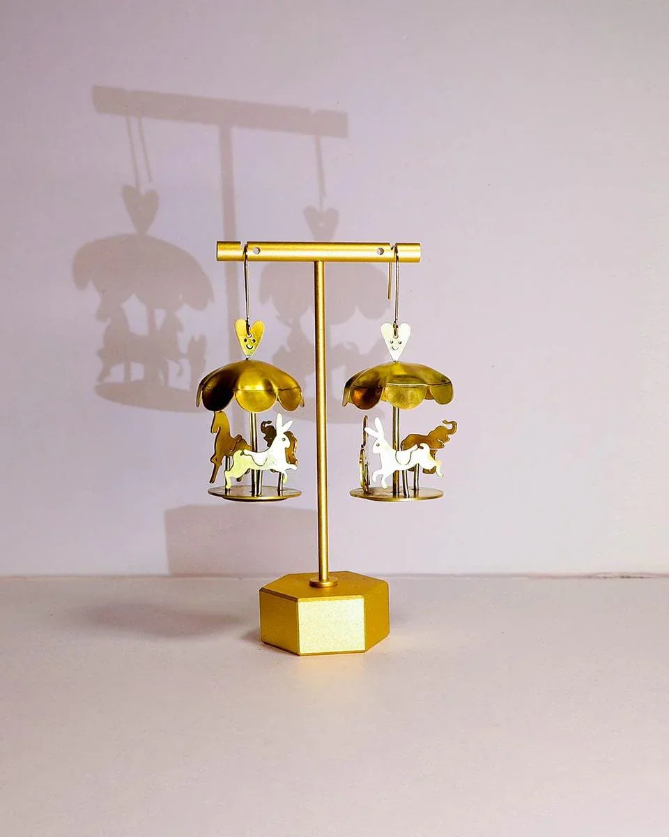 A kinetic miniature carousel earring, handmade from brass sheets, handcrafted jewellery, by fake plastic love