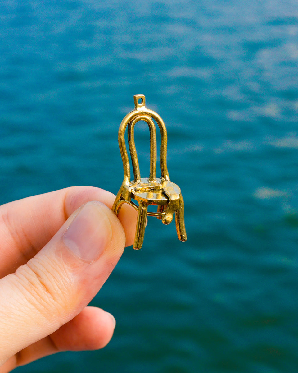 miniature brass chair with socks brass earring, handcrafted wearable sculpture
