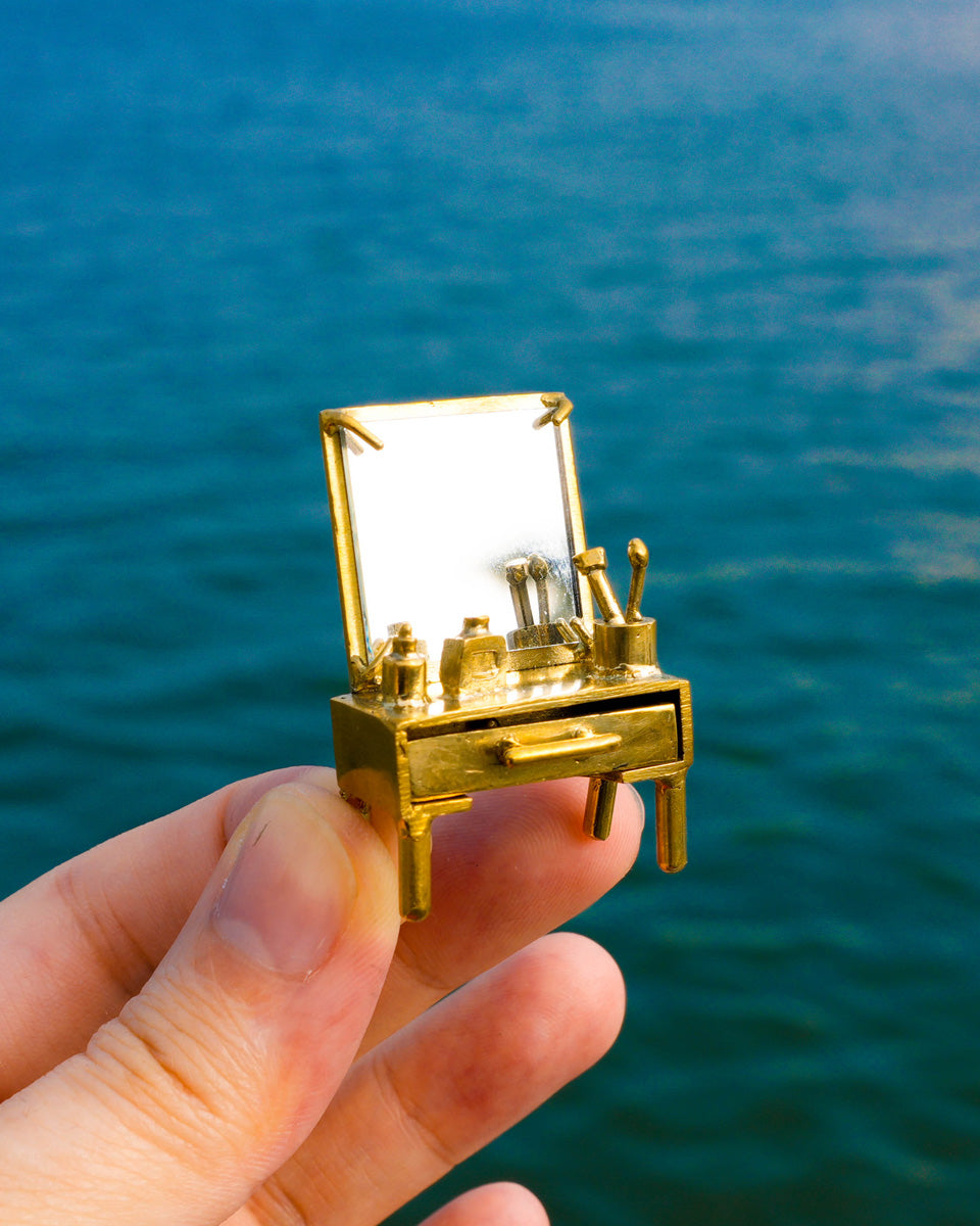 close up of handmade miniature Vanity table Jewellery - Functional Drawer and Mirror Pendant/Earring in brass