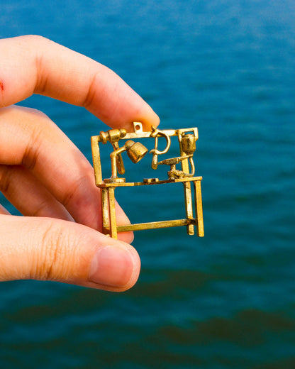 Miniature jeweller’s bench earring in brass with bench peg and tools, handcrafted wearable sculpture