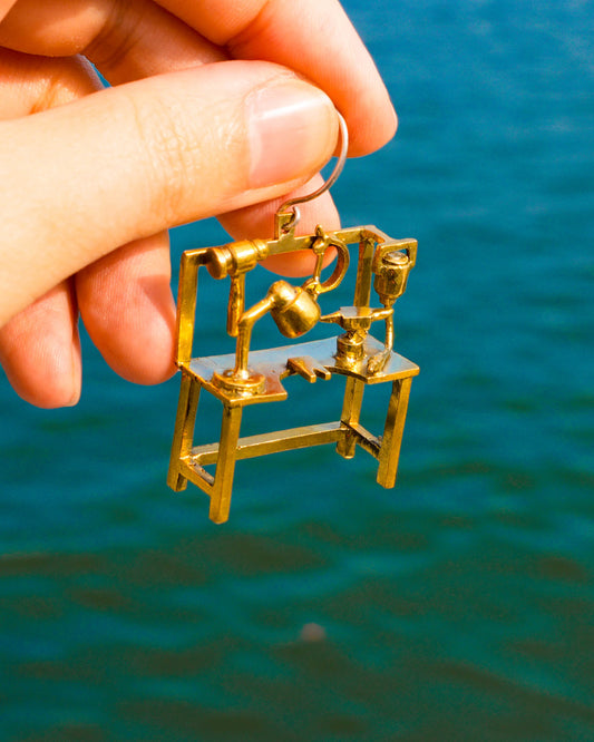 Miniature jeweller’s bench earring in brass with bench peg and tools, handcrafted wearable sculpture