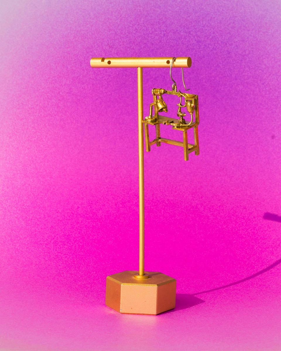 Miniature jeweller’s bench earring in brass with bench peg and tools, handcrafted wearable sculpture