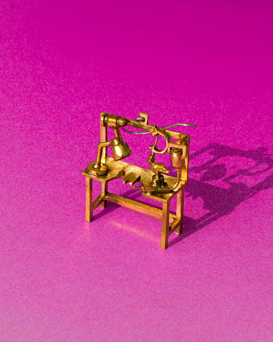 Miniature jeweller’s bench earring in brass with bench peg and tools, handcrafted wearable sculpture