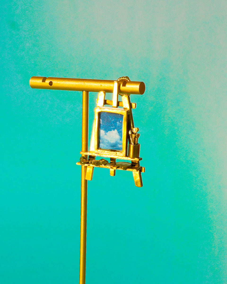 Miniature painting stand earring in brass with artist easel, brushes, palette, and paint tubes