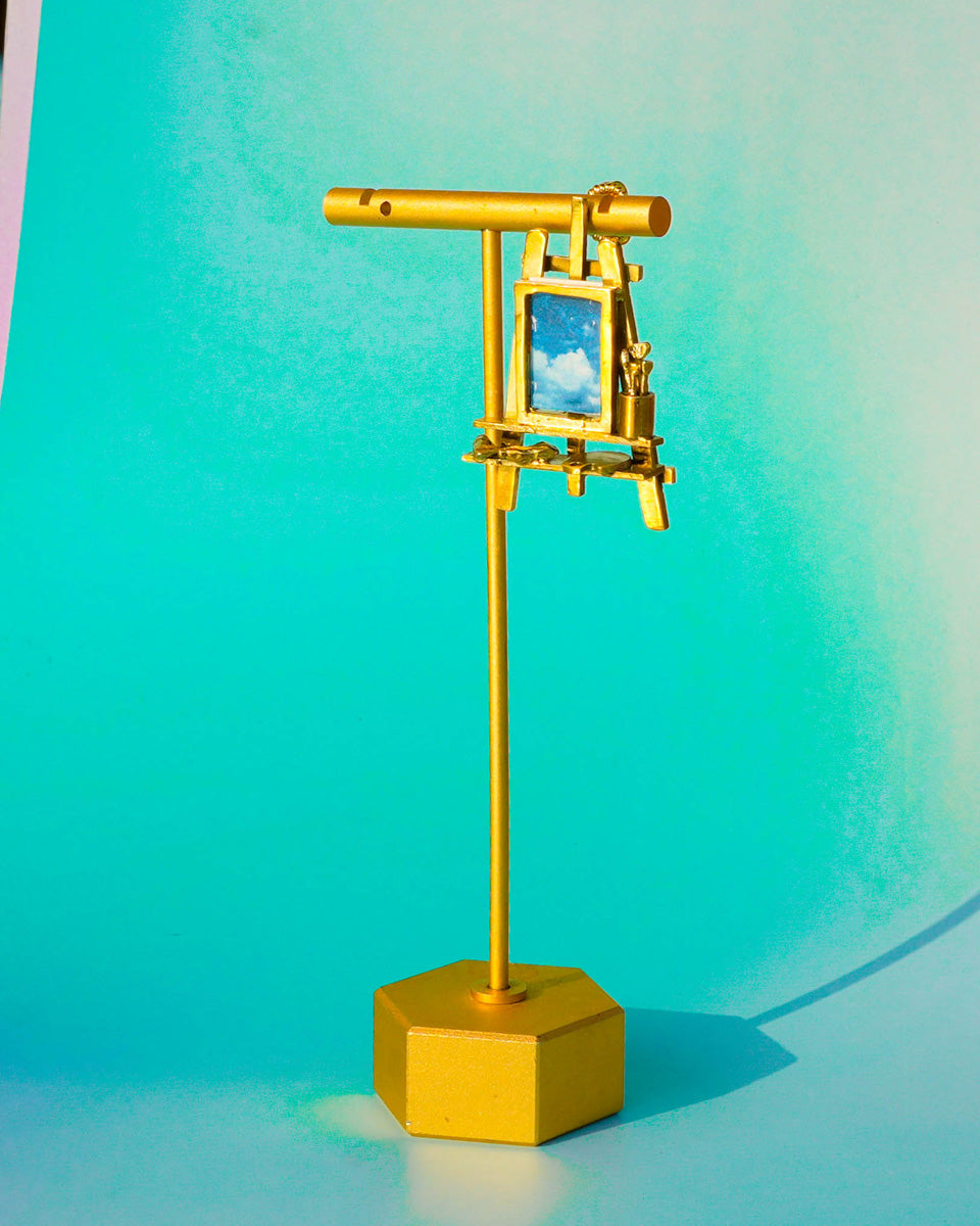 Miniature painting stand earring in brass with artist easel, brushes, palette, and paint tubes