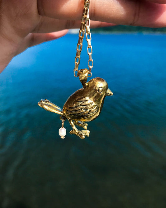 handmade brass pooping bird pendant that poops out a freshwater pearl, by fake plastic love
