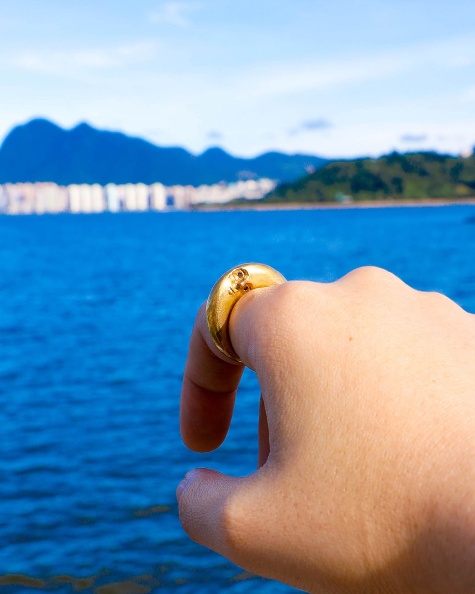 woman hand wearing Solid brass Celestial full Moon Ring for Mid-Autumn Festival, featuring moon faces on the sides symbolizing family reunion and harmony