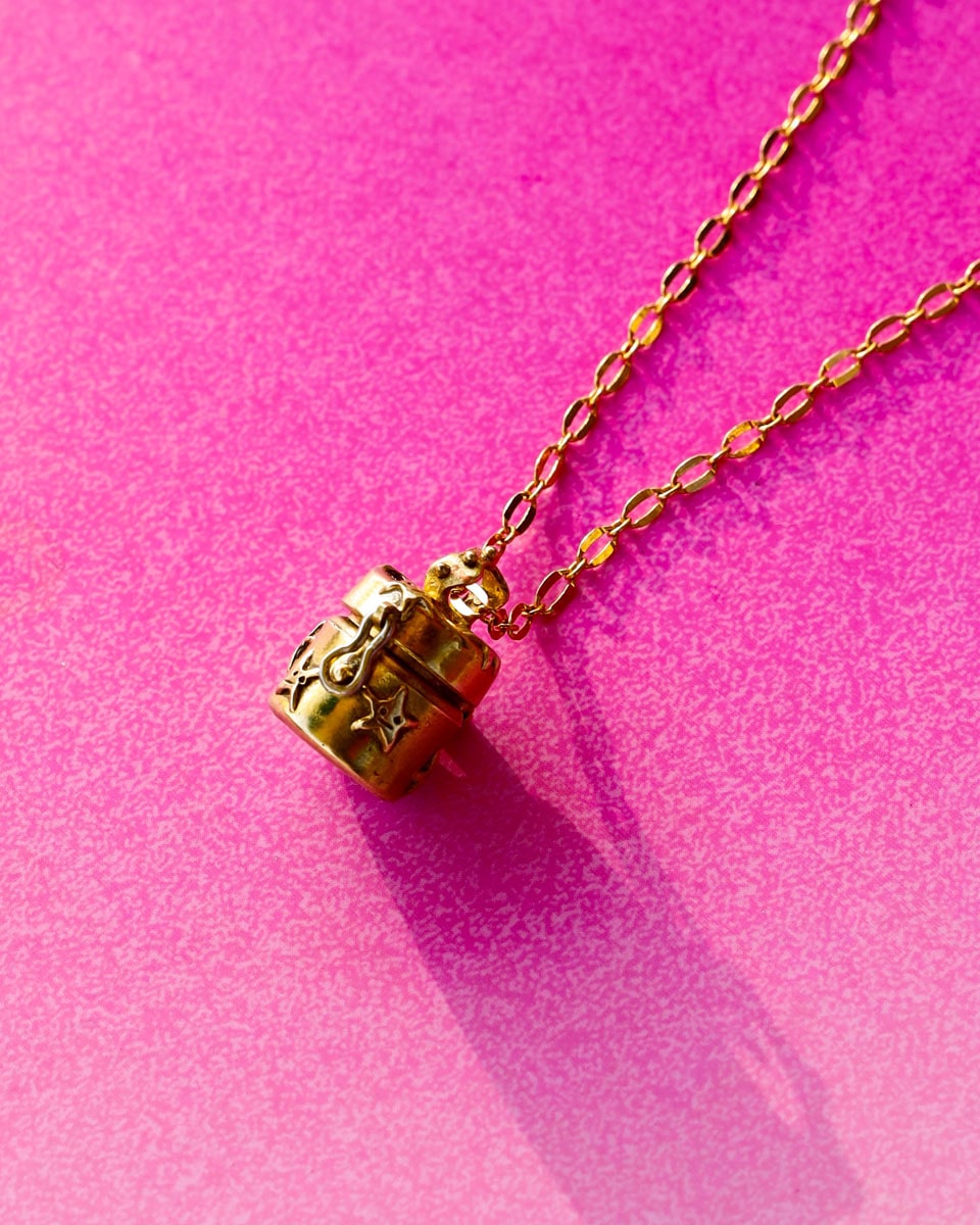 a solid brass locket with stars design, handmade small container locket pendant
