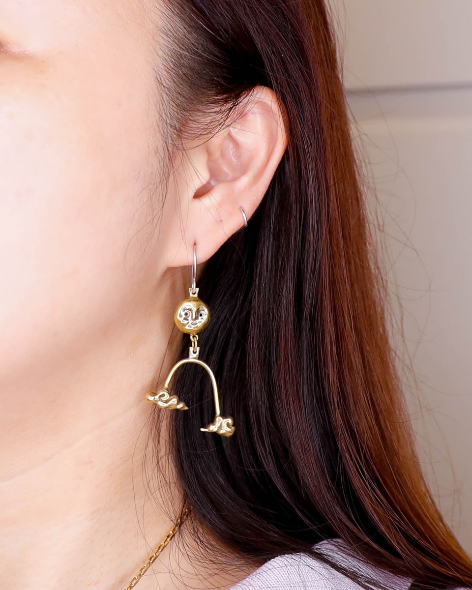model wearing the Moon's Blessing celestial dangle earring in solid brass, featuring a full moon and two auspicious cloud