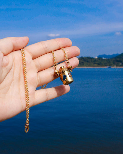 The Alchemist Locket Necklace, a handmade brass tiny container locket with cz stones and flowers details with gold plated chain, crafted by fake plastic love