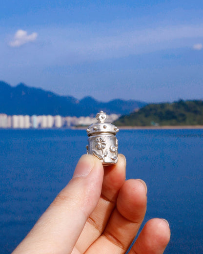 A solid sterling silver container locket pendant with flower, hand-carved with wax cast into silver, with a functional hinged lid. Handmade by fake plastic love
