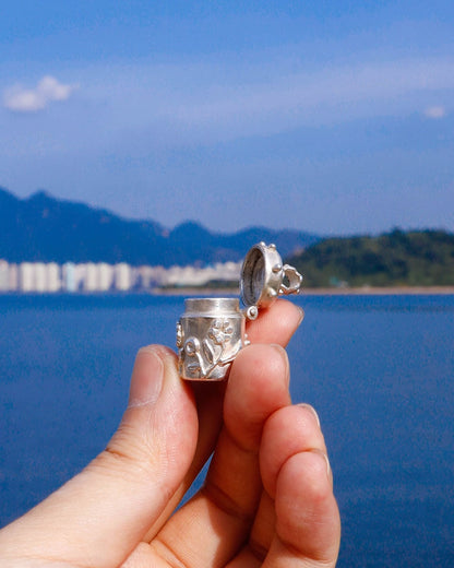 A solid sterling silver container locket pendant with flower, hand-carved with wax cast into silver, with a functional hinged lid. Handmade by fake plastic love