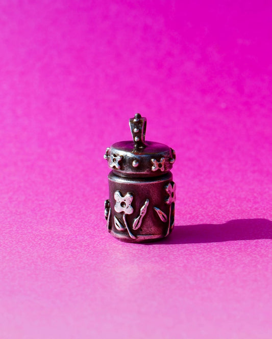 A solid sterling silver container locket pendant with floral details in patina finish, hand-carved with wax cast into silver, with a functional hinged lid. Handmade by fake plastic love