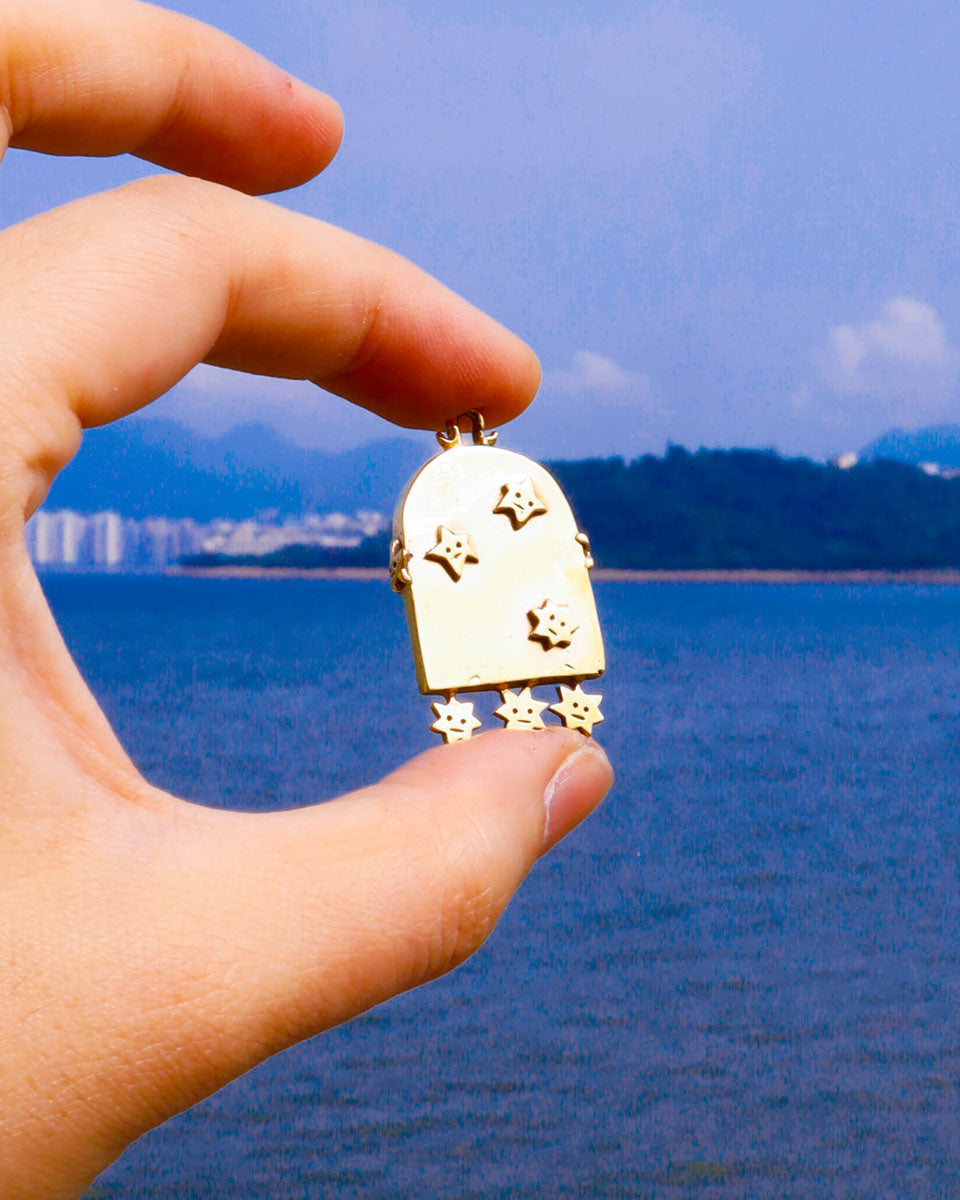 brass arched-shaped charm with stars design, handmade jewellery with a functional mirror