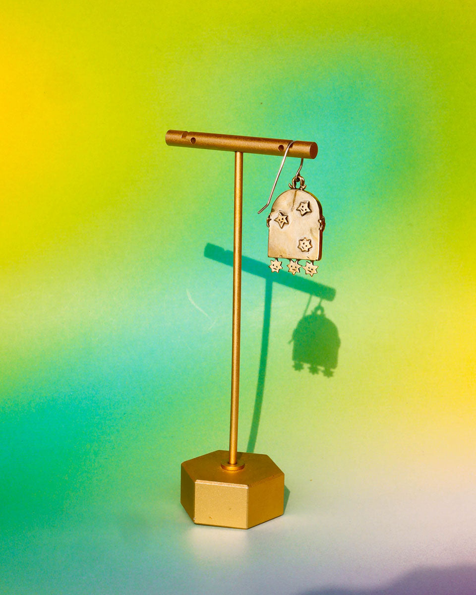 earring with an arched-shaped mirror with stars design on a gold earring stand