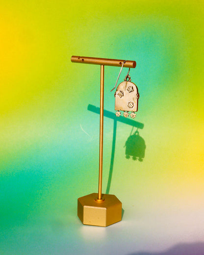 earring with an arched-shaped mirror with stars design on a gold earring stand