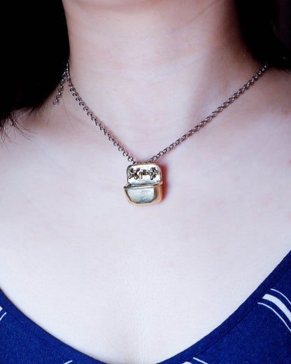 Miniature tiny sink pendant in solid brass with sterling silver necklace, featuring movable faucet knobs and a detailed cast design inspired by a household bathroom sink