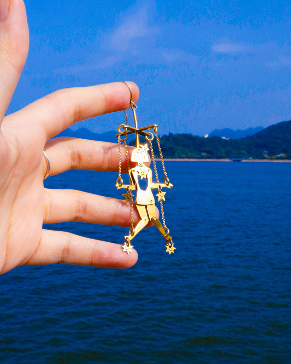 Mini articulated puppet earrings in brass, smaller version of “The Person Controlled By The Stars”, handmade sculptural jewelry