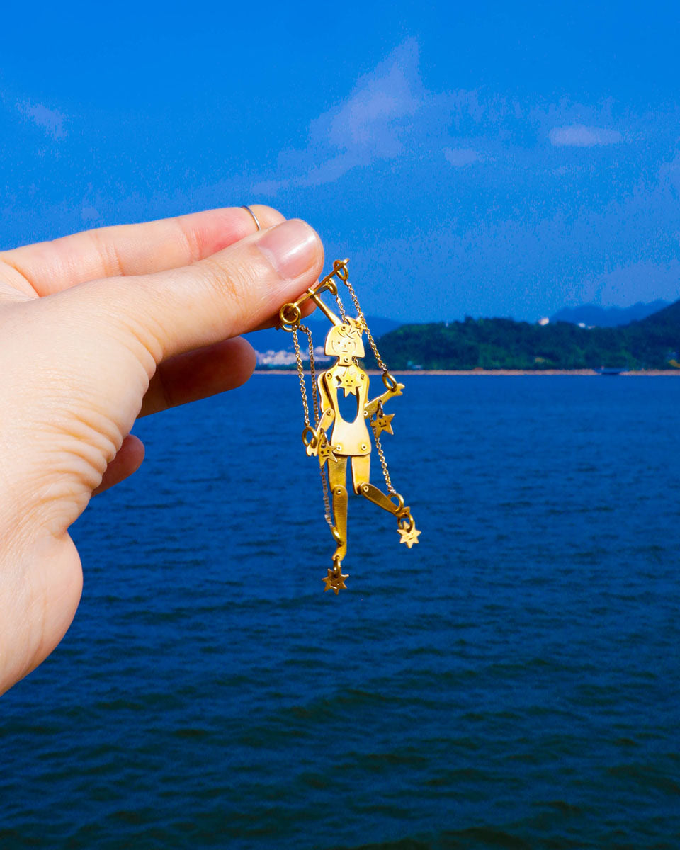 Mini articulated puppet earrings in brass, smaller version of “The Person Controlled By The Stars”, handmade sculptural jewelry